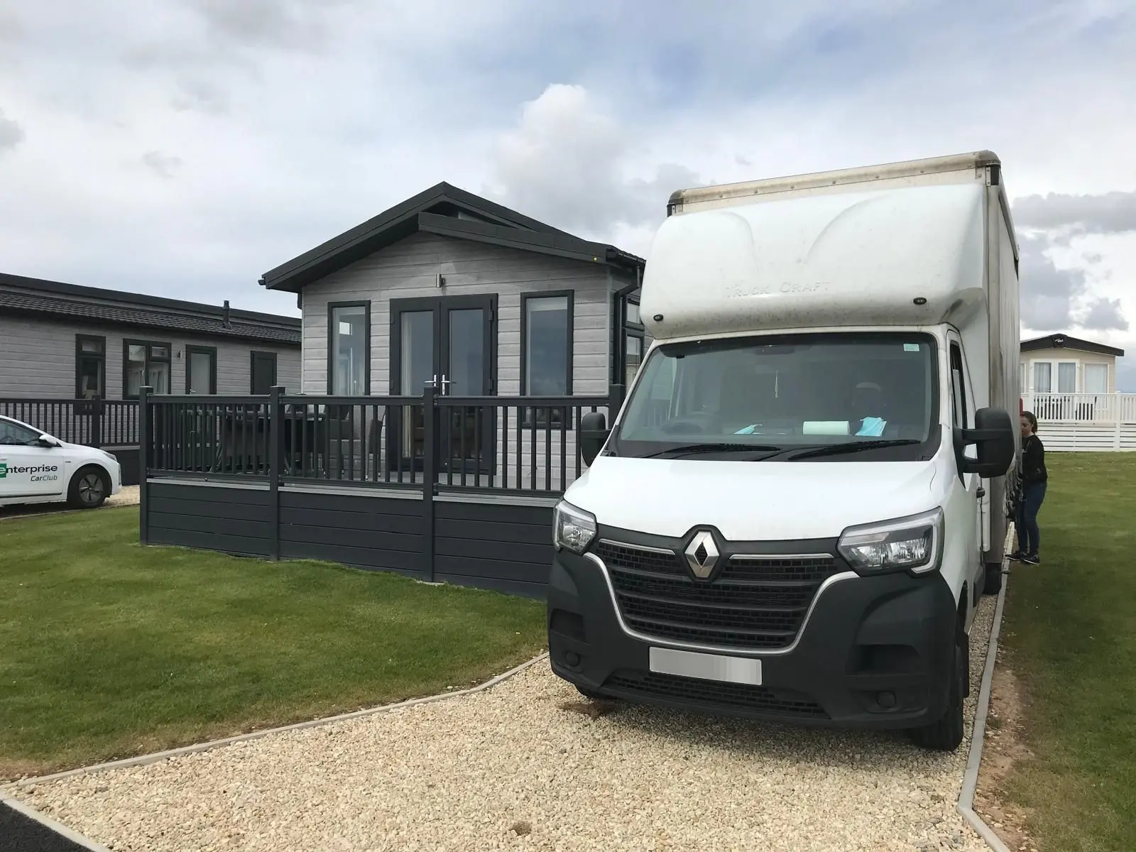 A front view of a large van parked on the drive of a holiday home