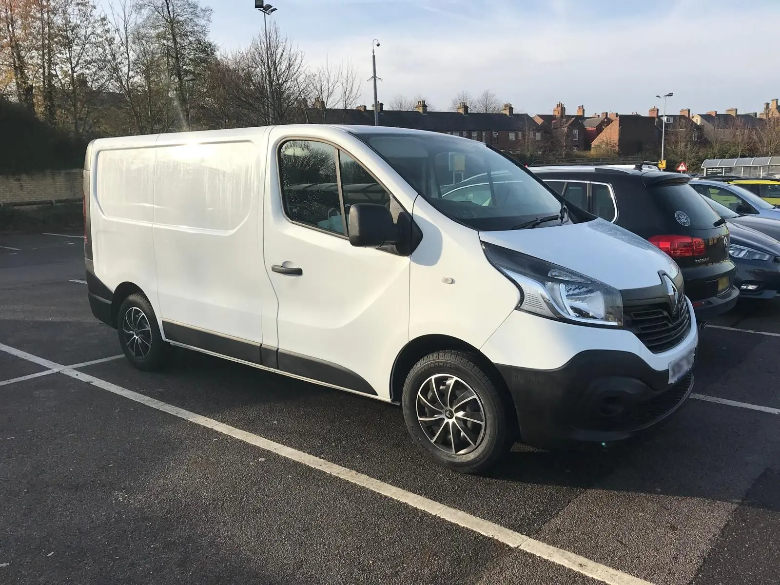 A white renault van in a car park.